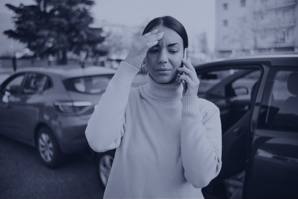 Woman on the phone after getting in a car accident