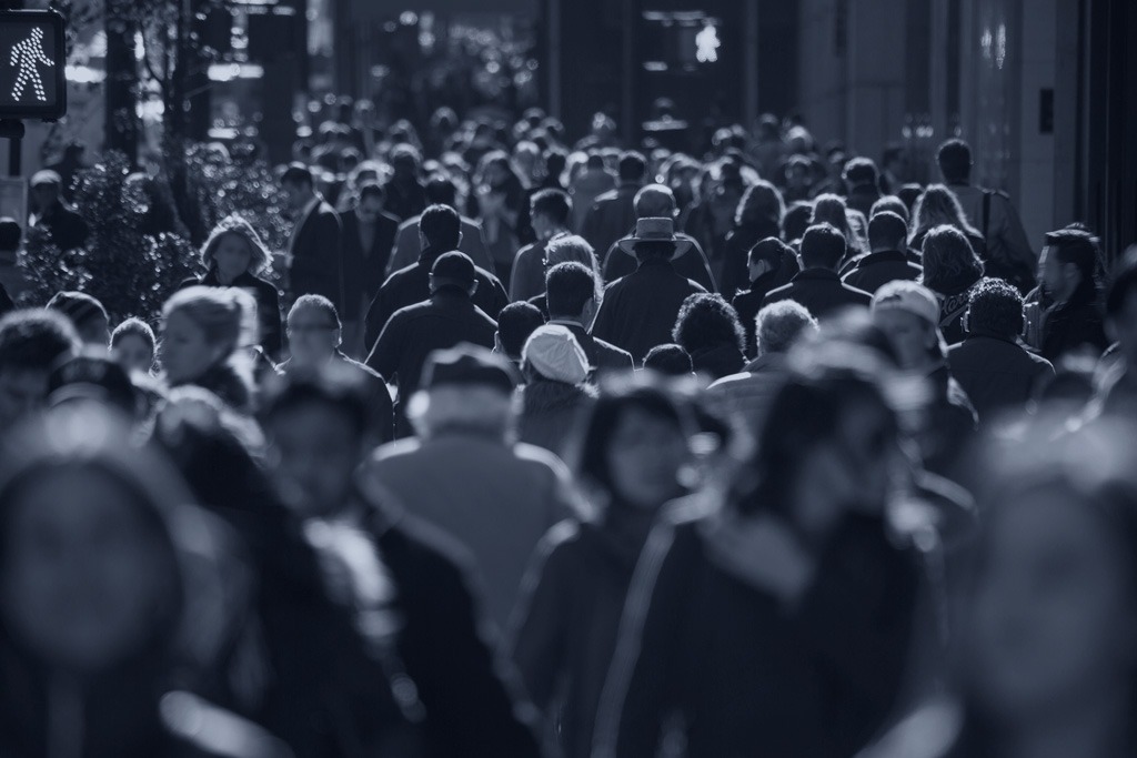 Crowd of anonymous people walking on busy New York City street