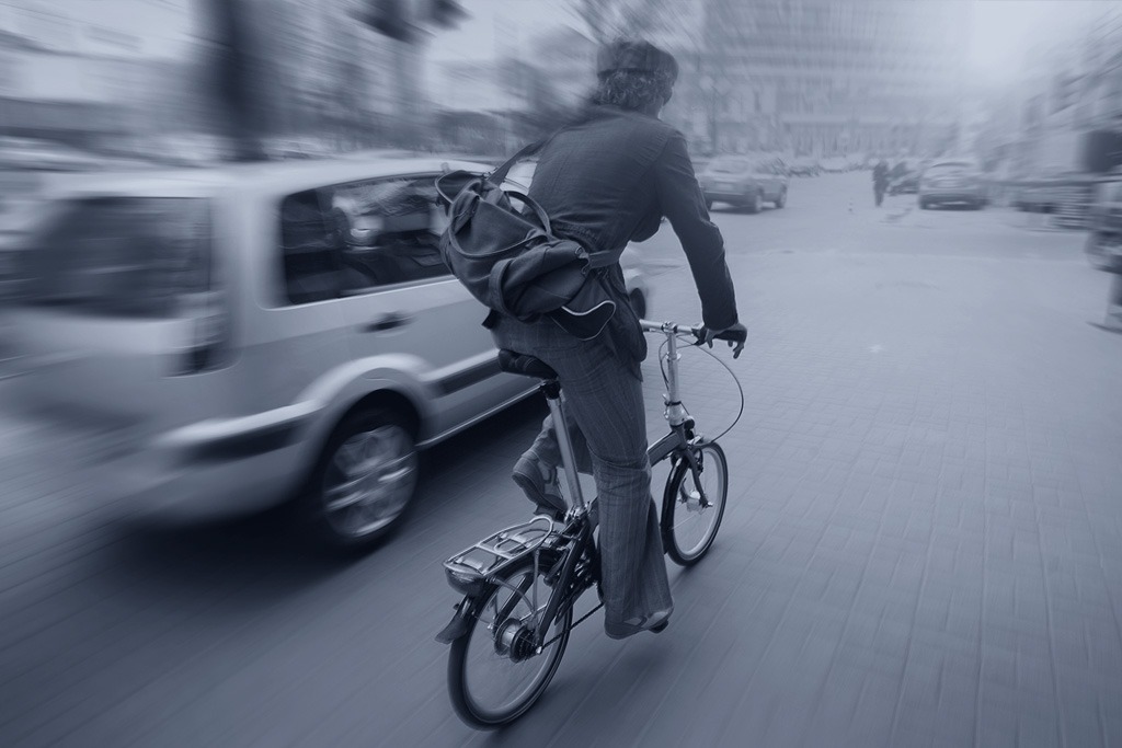cyclist in traffic on the city roadway