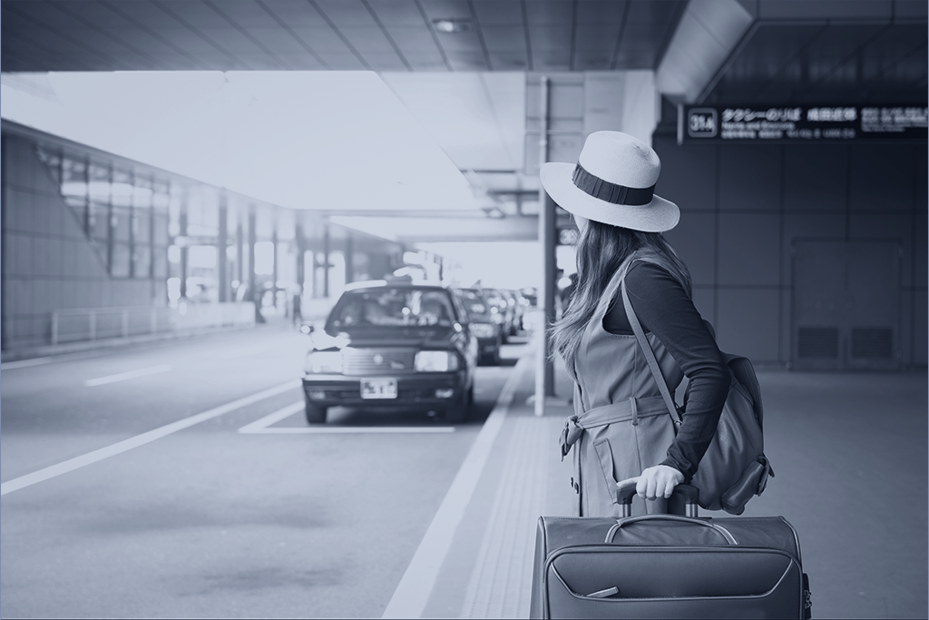 Smiling woman using cell phone to call uber